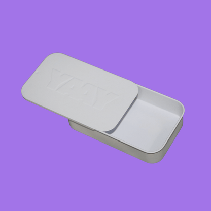 The YAAY Aluminium Travel Tin with a lid on a purple background